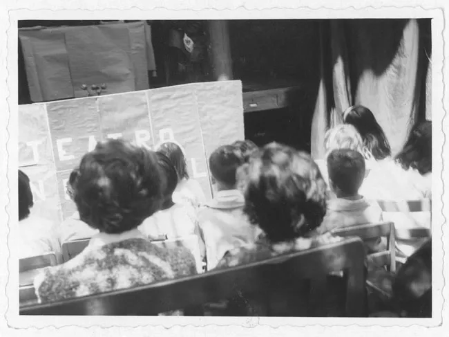 Niños frente a un escenario de marionetas