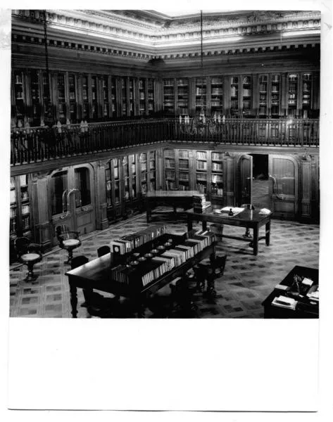 [Biblioteca Nacional. Sala de lectura de la Biblioteca Americana de Diego Barros Arana, se divisan unos escritorios y una mesa rectangular con libros]  [fotografía]