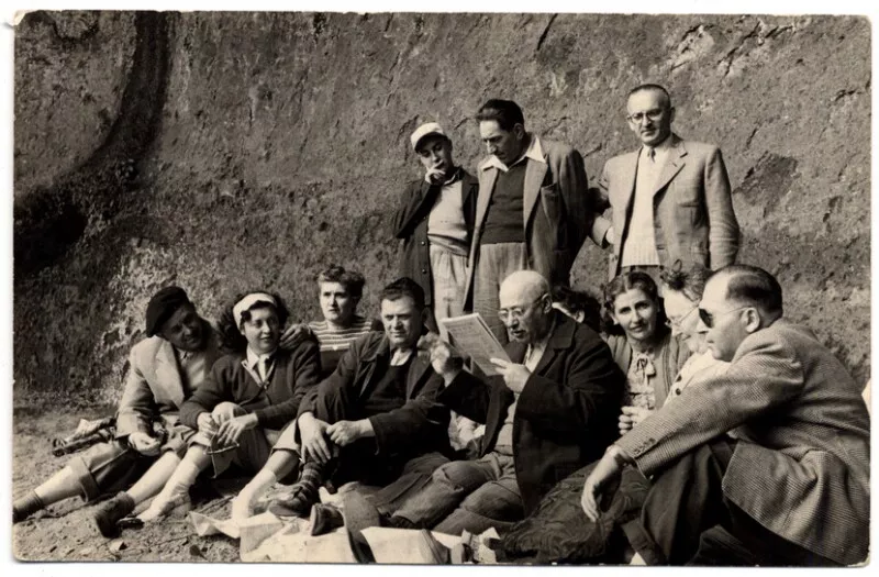 [Grupo de personas alrededor de hombre que lee en voz alta en Termas de Chillán]  [fotografía] [Fotografía de Francisco Bley].